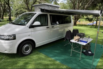 VanTom. Unique design where the pop-top is in the middle
Of the van where you can stand up in the kitchen area.