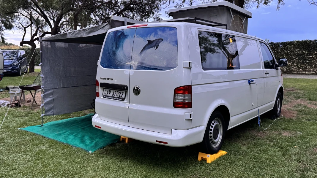 VanTom. Unique design where the pop-top is in the middle
Of the van where you can stand up in the kitchen area. photo 4