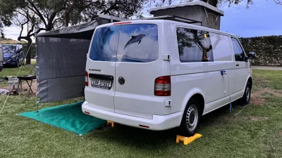 VanTom. Unique design where the pop-top is in the middle
Of the van where you can stand up in the kitchen area.
