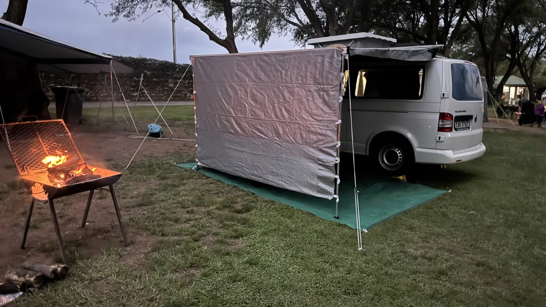 VanTom. Unique design where the pop-top is in the middle
Of the van where you can stand up in the kitchen area. photo 5