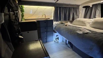 VanTom. Unique design where the pop-top is in the middle
Of the van where you can stand up in the kitchen area.